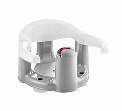 A white anti-slip bath and feeding seat for infants, with a secure back support and a red safety strap. Available at Kaya kids